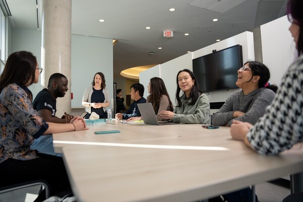 instructor and students around a table